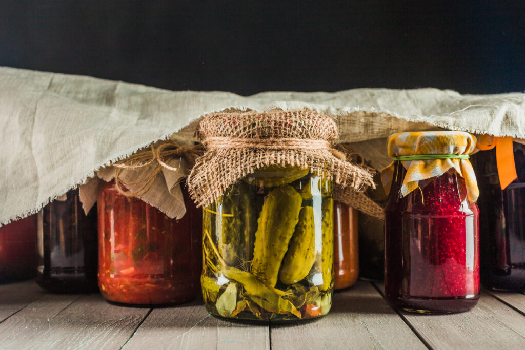 Preserved vegetables on wooden background